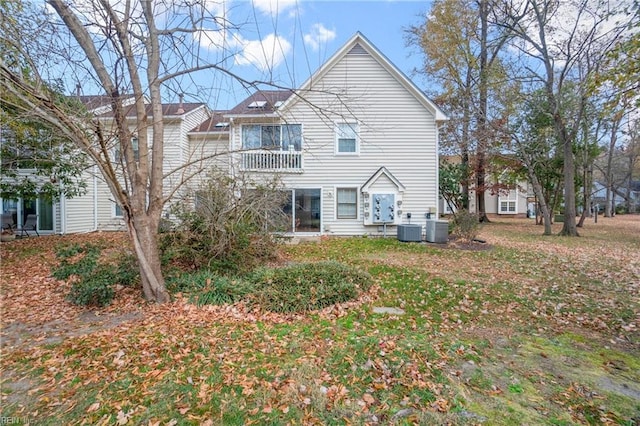 rear view of property featuring central AC