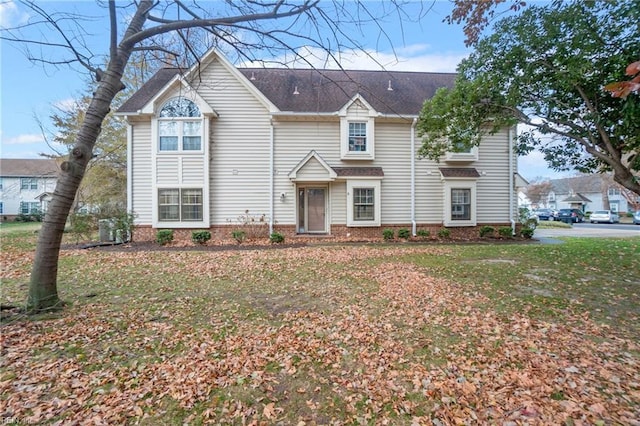 view of front facade with a front yard and central AC