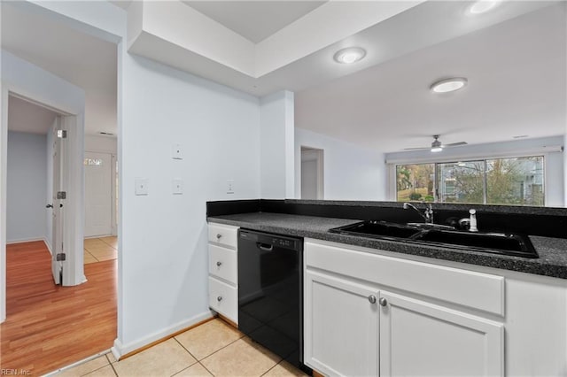 kitchen with sink, ceiling fan, light tile patterned floors, black dishwasher, and white cabinetry