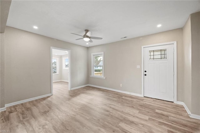 foyer entrance with ceiling fan and light wood-type flooring