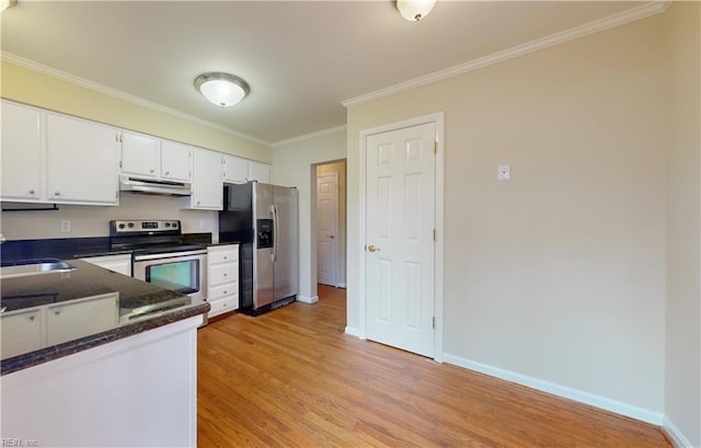 kitchen with ornamental molding, stainless steel appliances, light hardwood / wood-style flooring, dark stone countertops, and white cabinetry