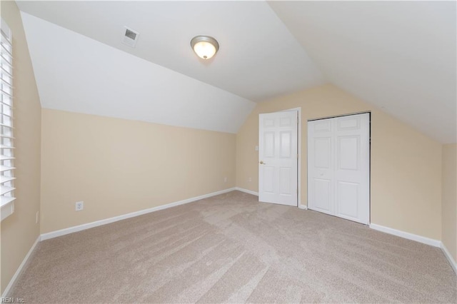 bonus room featuring light carpet and lofted ceiling