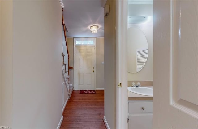 doorway to outside with wood-type flooring and sink