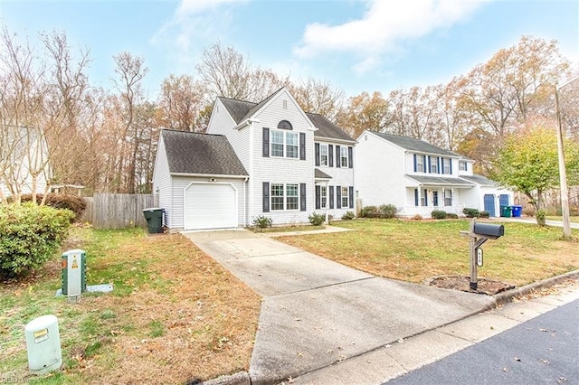 view of property with a front yard and a garage