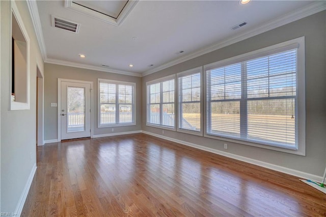 spare room with light wood-type flooring and ornamental molding