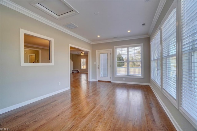 spare room featuring light hardwood / wood-style floors, ceiling fan, and crown molding