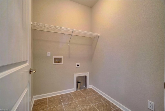 laundry area featuring washer hookup, dark tile patterned flooring, and hookup for an electric dryer