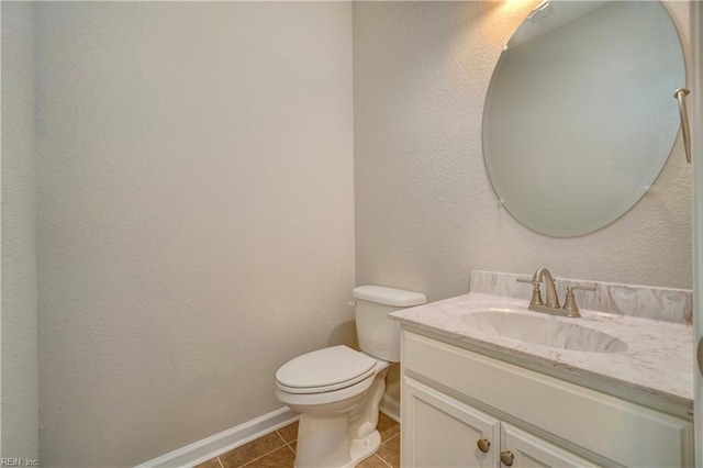 bathroom featuring tile patterned flooring, vanity, and toilet