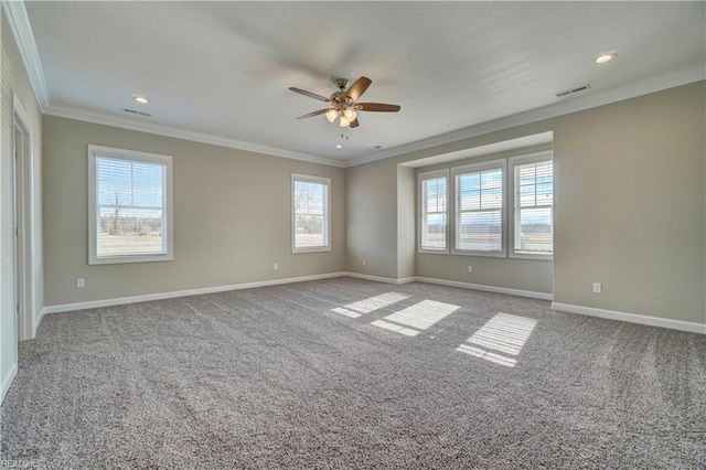 empty room featuring crown molding, ceiling fan, a healthy amount of sunlight, and light carpet