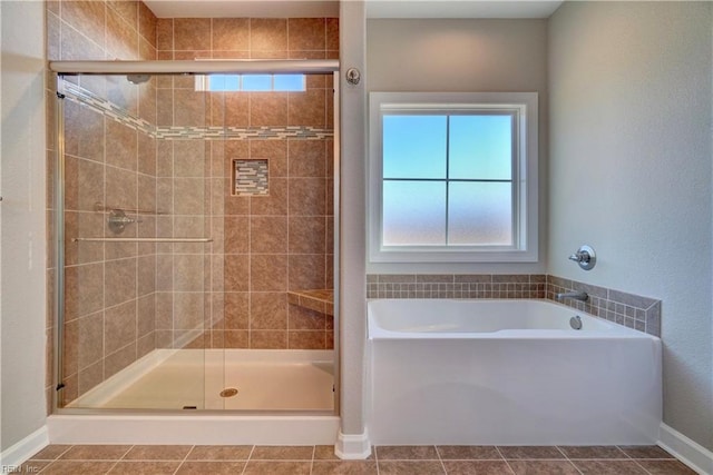 bathroom featuring tile patterned floors and separate shower and tub