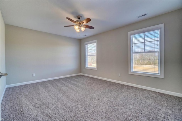 unfurnished room featuring carpet floors, ceiling fan, and a healthy amount of sunlight