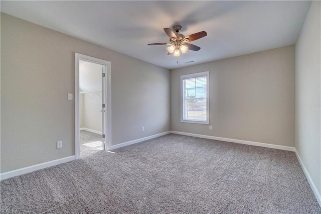 unfurnished room with carpet flooring and ceiling fan