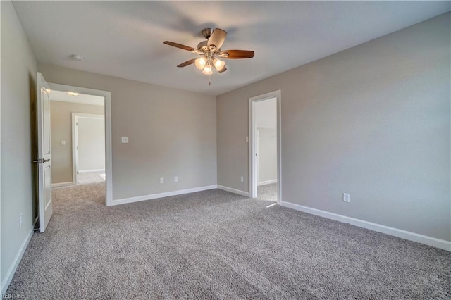 carpeted empty room featuring ceiling fan