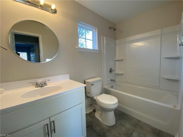 full bathroom with toilet, tile patterned flooring,  shower combination, and vanity