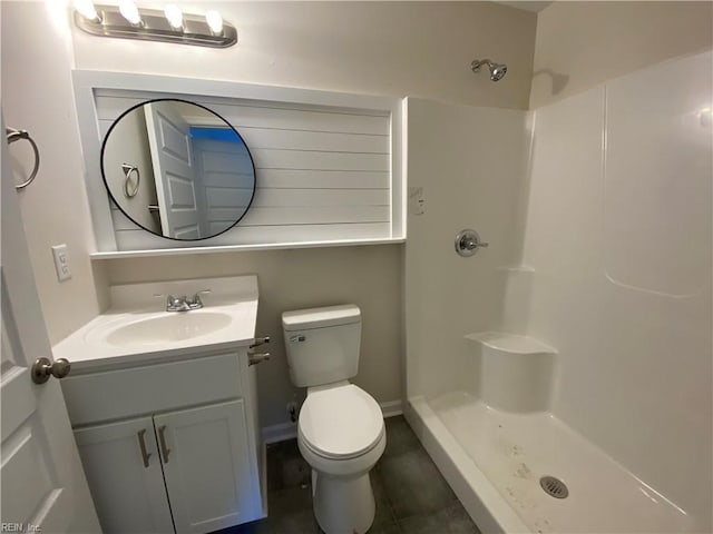 bathroom with toilet, walk in shower, and vanity