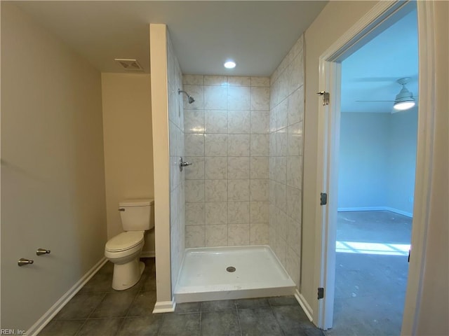 bathroom featuring toilet, ceiling fan, and a tile shower