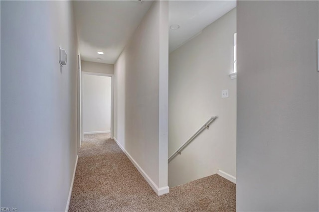 hallway with light colored carpet