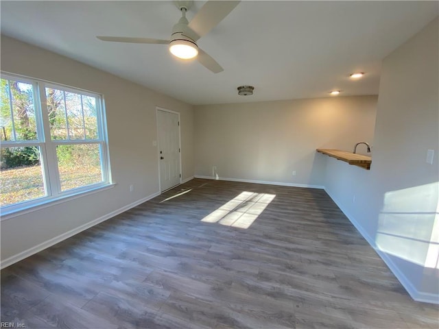 unfurnished room featuring ceiling fan and dark hardwood / wood-style floors