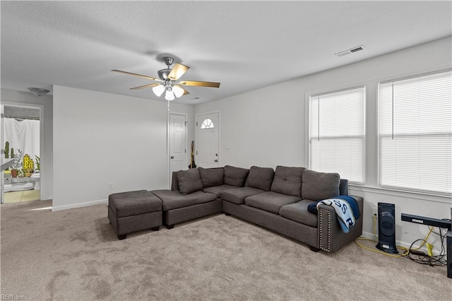 carpeted living room featuring ceiling fan