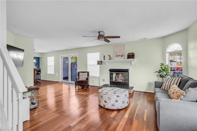 living room featuring ceiling fan and wood-type flooring