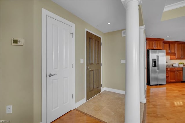 interior space with ornate columns and light wood-type flooring