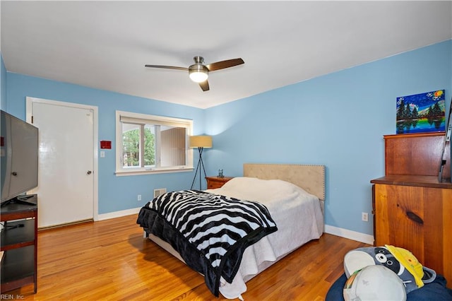 bedroom with ceiling fan and light wood-type flooring