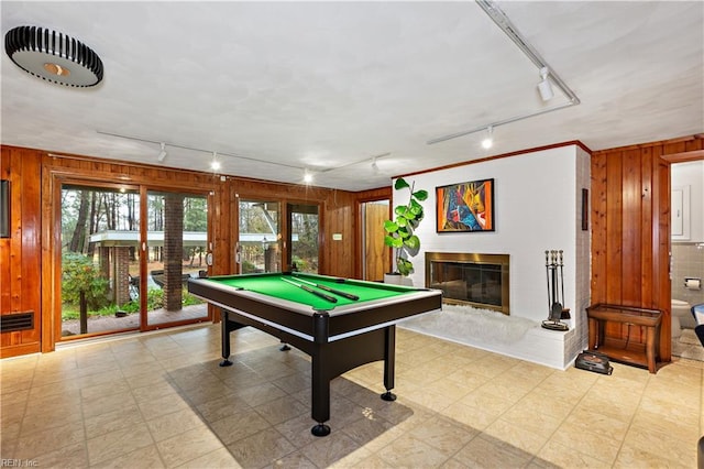 rec room with wood walls, rail lighting, and pool table