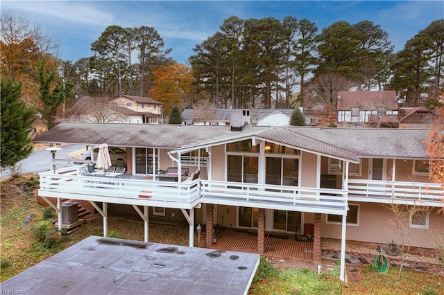 rear view of property with cooling unit and a deck