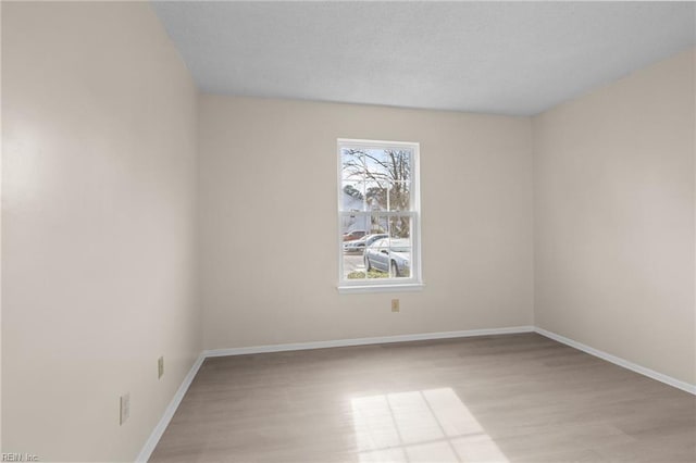 unfurnished room with light wood-type flooring