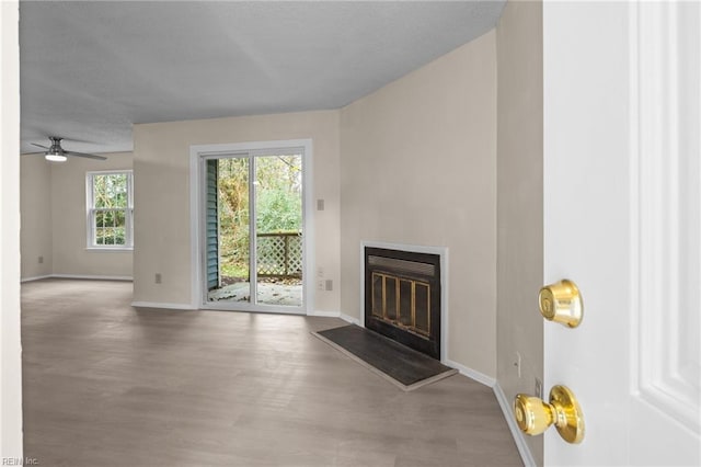 unfurnished living room featuring hardwood / wood-style flooring and ceiling fan