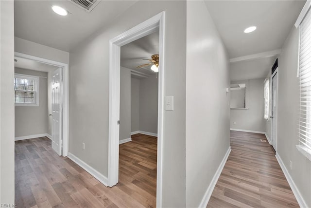 corridor with light hardwood / wood-style flooring