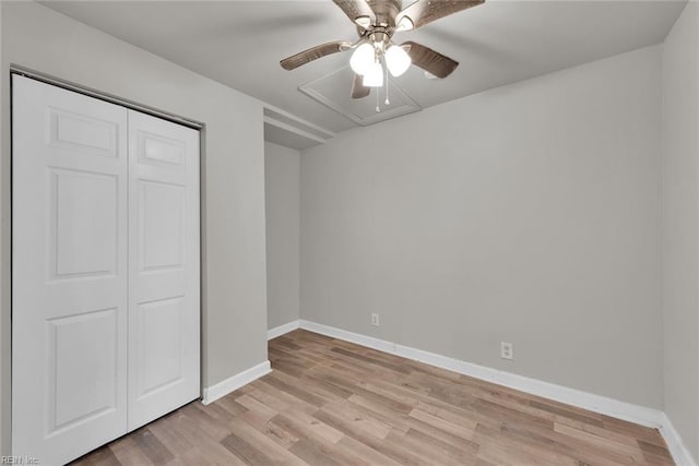 unfurnished bedroom featuring ceiling fan, light hardwood / wood-style floors, and a closet