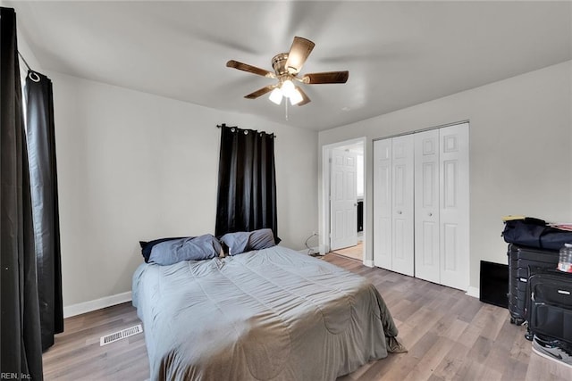 bedroom featuring hardwood / wood-style floors, ceiling fan, and a closet