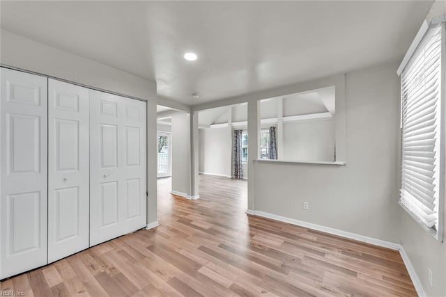 unfurnished bedroom featuring light hardwood / wood-style floors and a closet