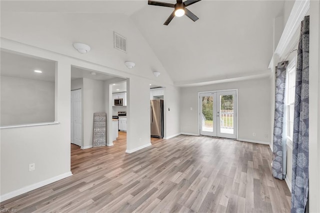 unfurnished living room featuring ceiling fan, light hardwood / wood-style floors, high vaulted ceiling, and french doors