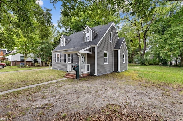 cape cod home with a front lawn