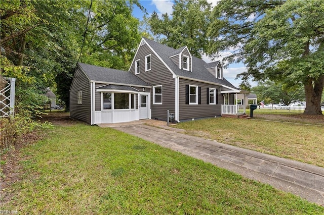 rear view of house featuring a lawn