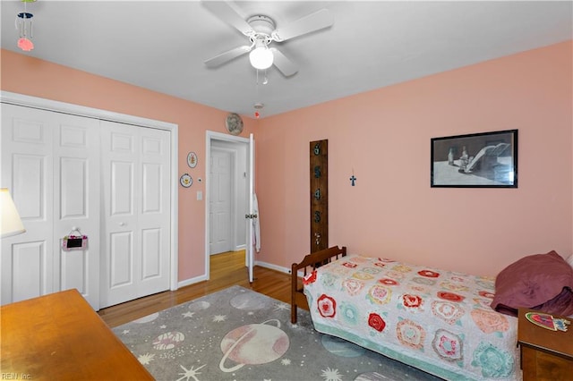 bedroom featuring wood-type flooring, a closet, and ceiling fan