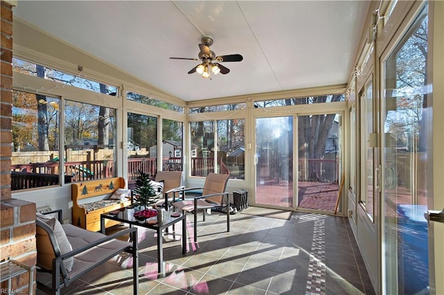 sunroom / solarium with ceiling fan and vaulted ceiling