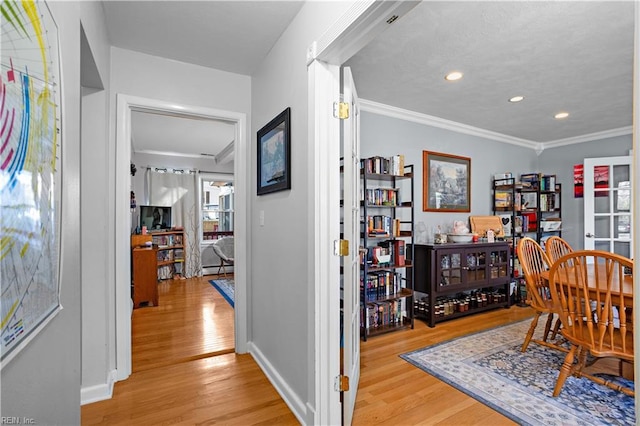 dining space featuring light hardwood / wood-style flooring and ornamental molding