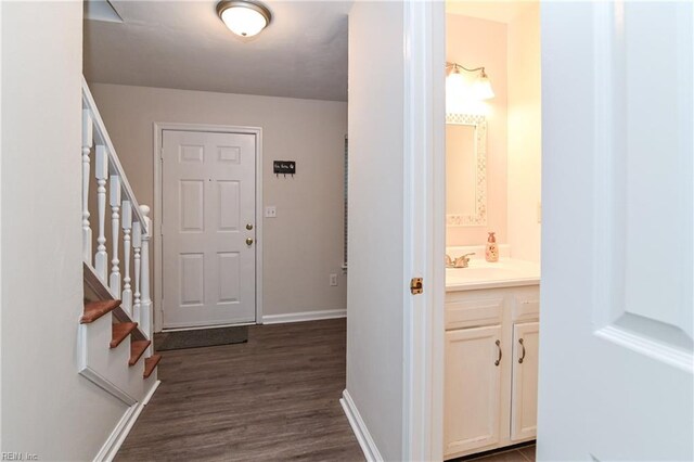 foyer with dark hardwood / wood-style flooring and sink