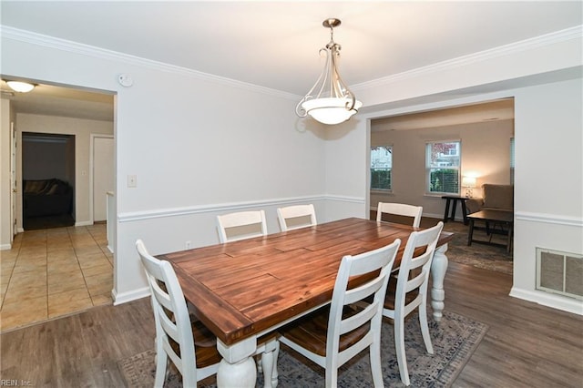 dining room featuring dark hardwood / wood-style flooring and ornamental molding