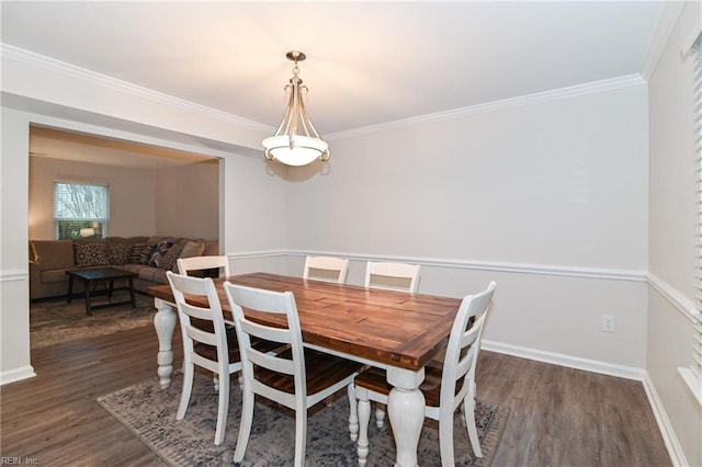 dining room featuring dark hardwood / wood-style floors and ornamental molding