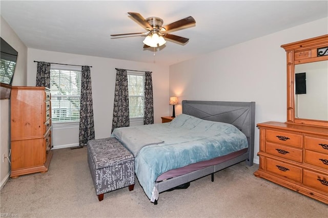 bedroom with light colored carpet and ceiling fan