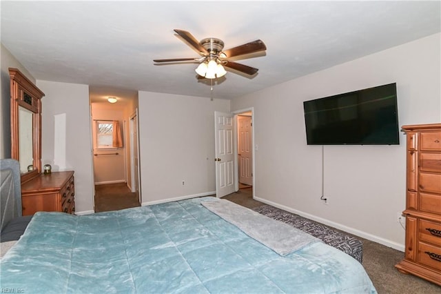 bedroom featuring dark colored carpet, connected bathroom, and ceiling fan