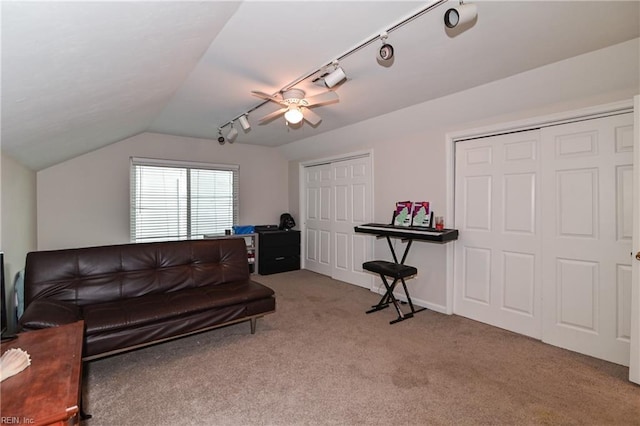 carpeted living room with ceiling fan, track lighting, and vaulted ceiling