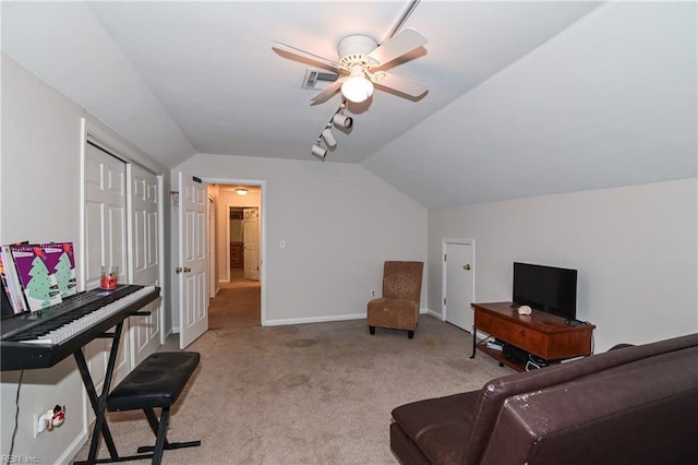 carpeted living room featuring ceiling fan and vaulted ceiling