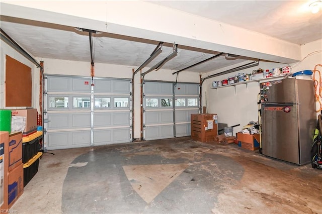 garage with stainless steel refrigerator