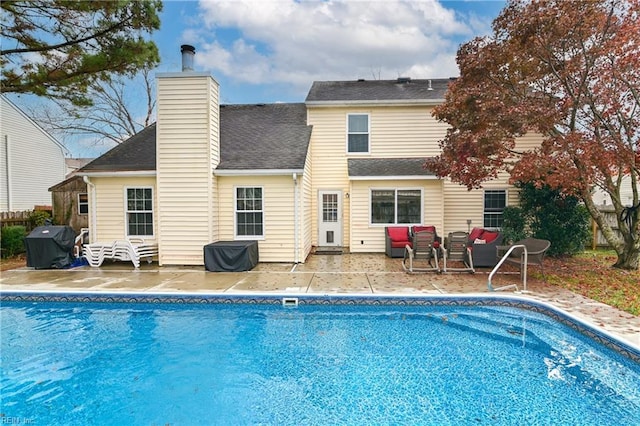 rear view of property featuring an outdoor living space and a patio