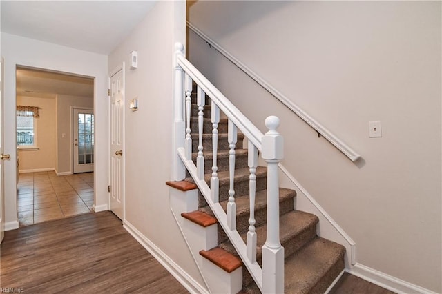 stairs with hardwood / wood-style flooring